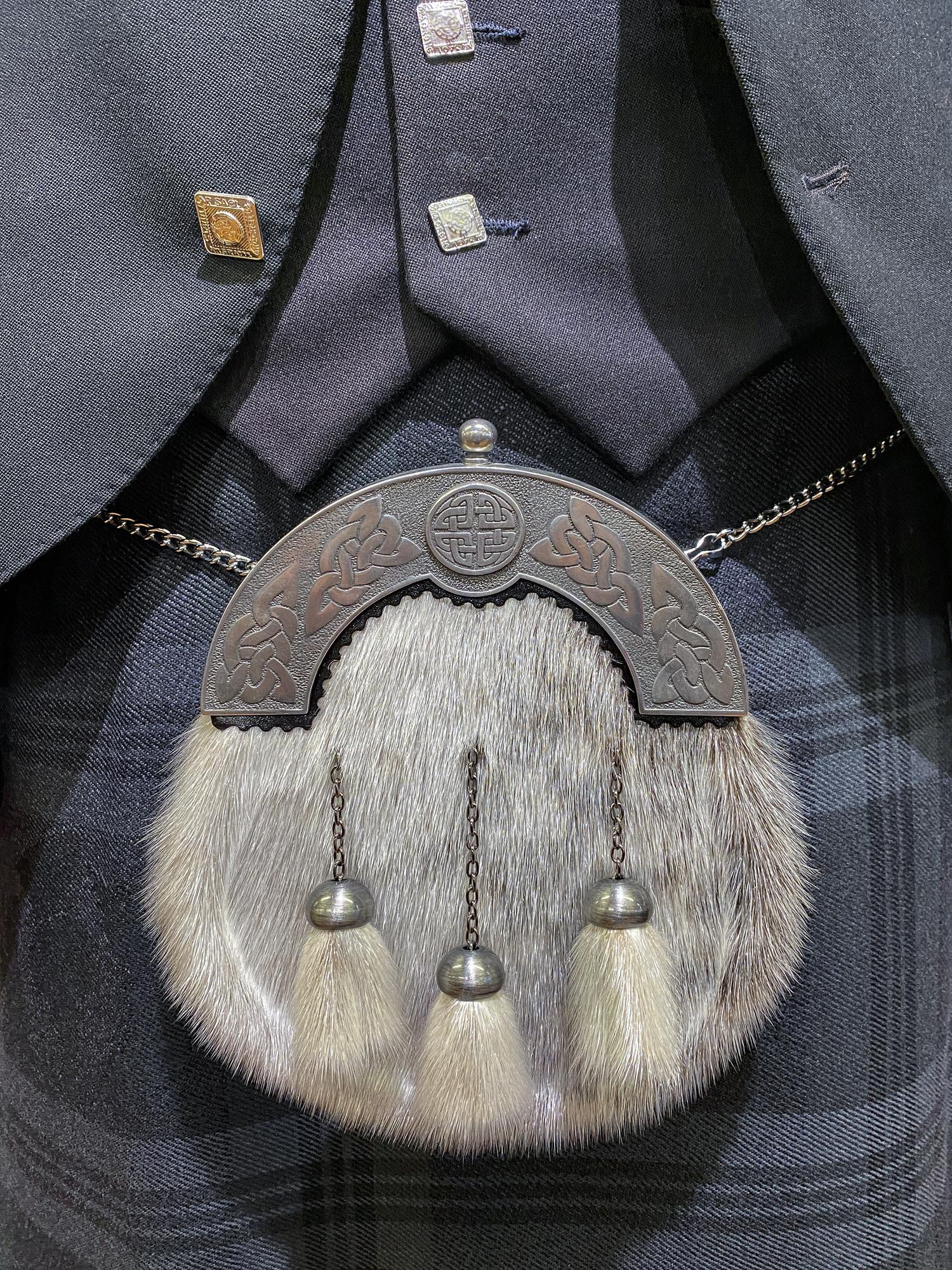 embroidered jacket cuff detail under studio light