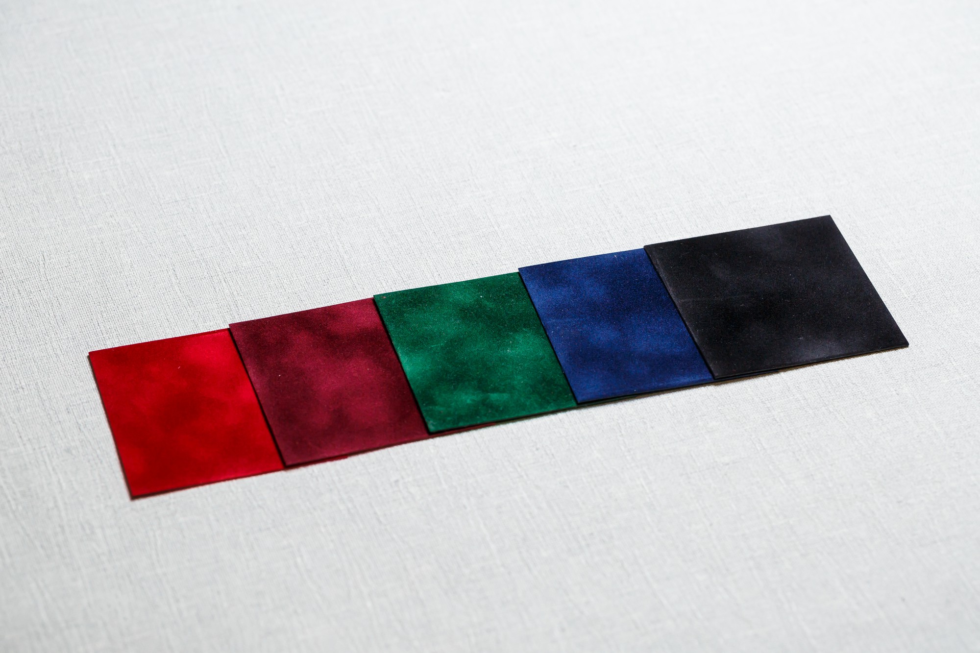 three sample embroidery swatches arranged overlapping